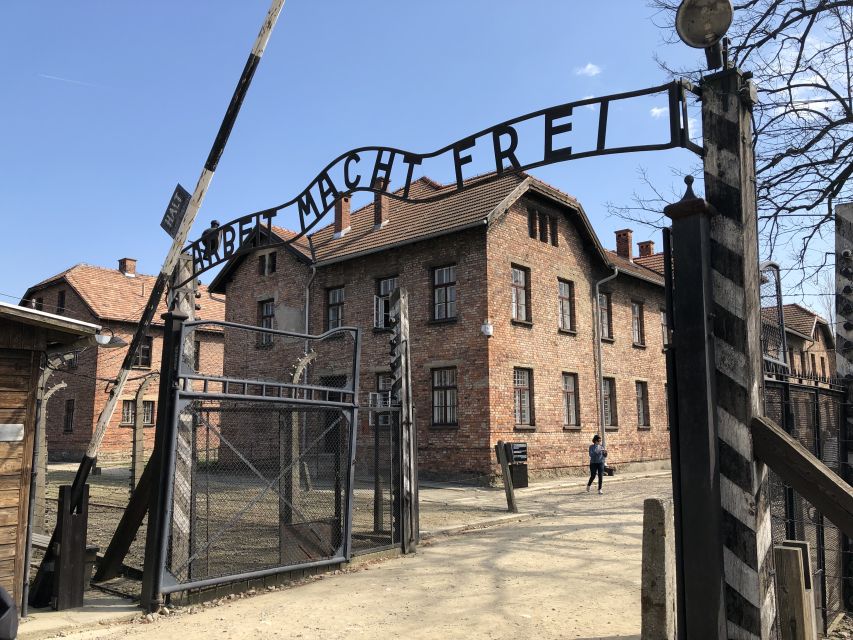 From Krakow: Auschwitz-Birkenau Guided Tour & Pickup - Entering Auschwitz I through Arbeit Macht Frei