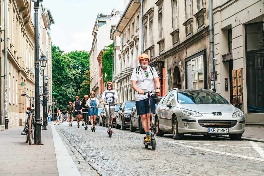 Krakow: Guided E-Scooter City Tour with Food Tastings - Starting at Plac Szczepański and entering the Old Town